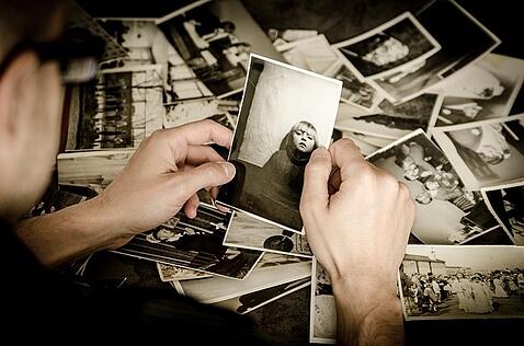 A Person Looking At Old Photos
